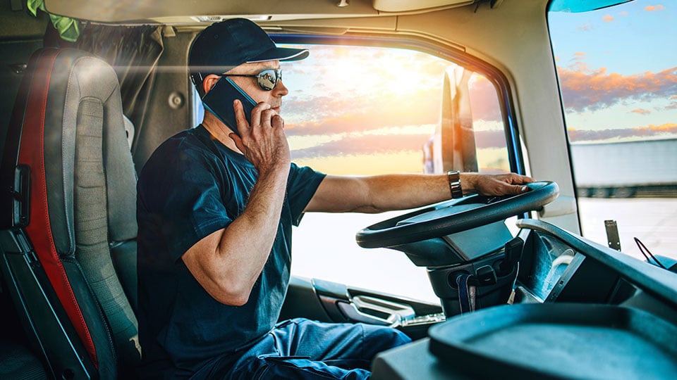 Truck-Driver-in-Semi-Truck-on-Phone
